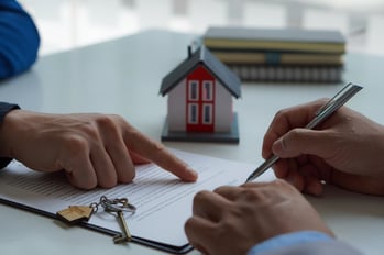 Person signing lease agreement