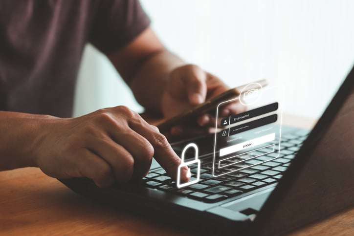 Man typing in password on computer