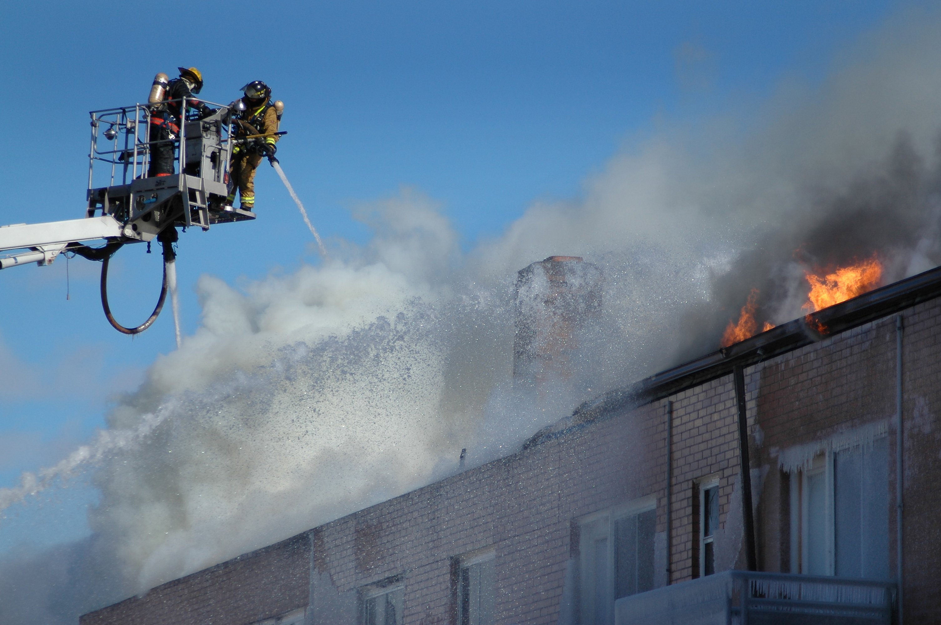 Firefighters battling fire on roof of apartment