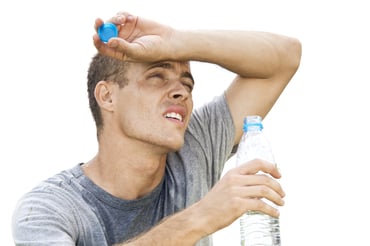 Man wiping sweat off face