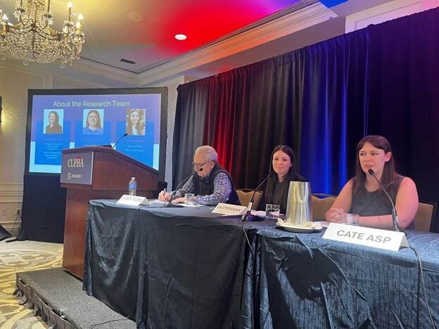 A group of people sitting at a podium

AI-generated content may be incorrect., Picture