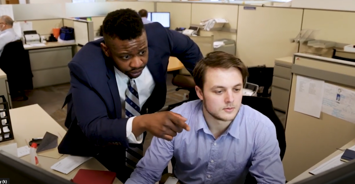 Two men in office working together. 