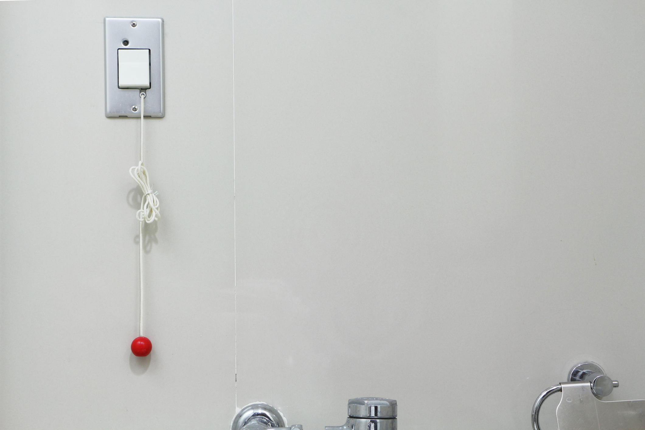 Emergency pull cord in bathroom stall