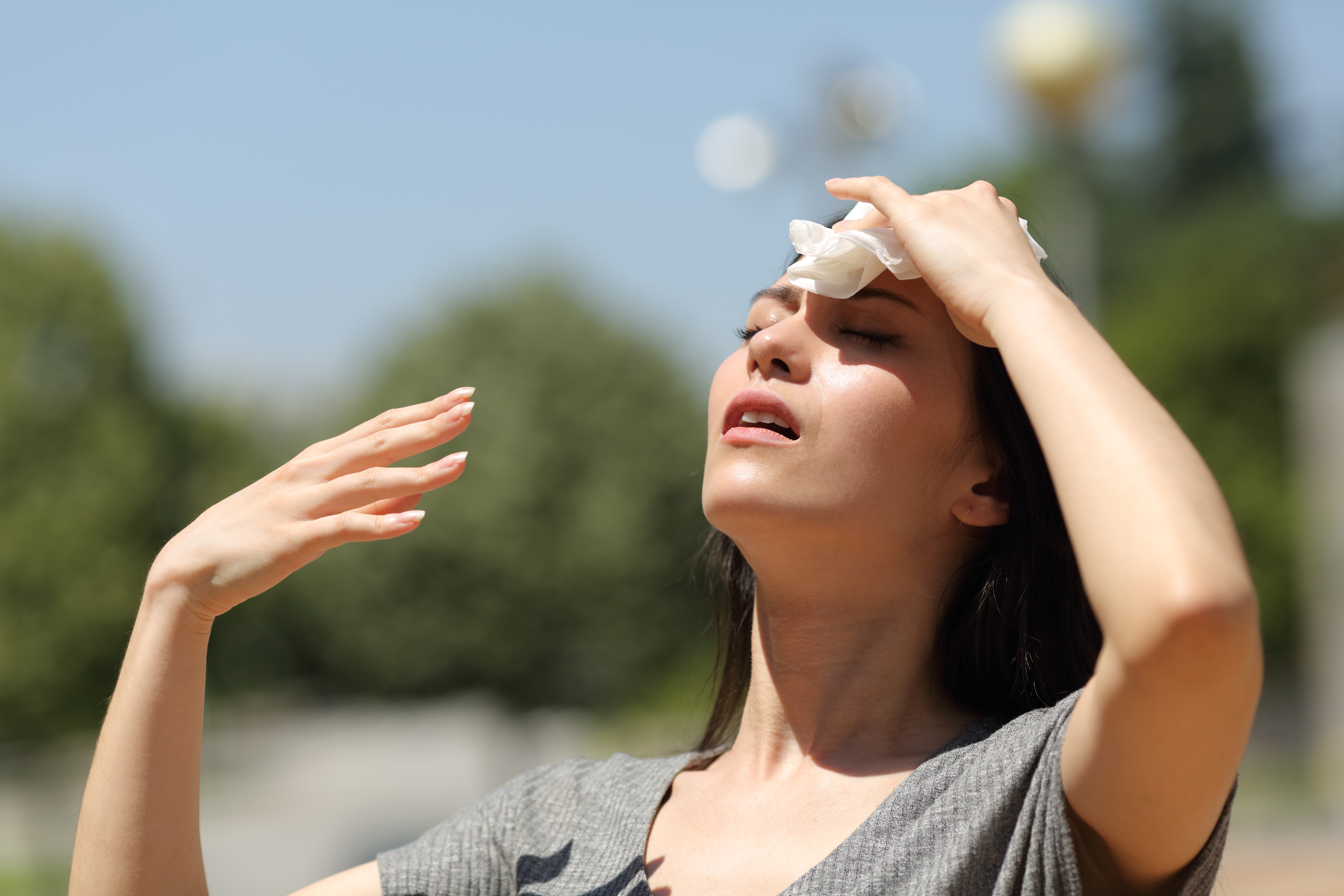 Woman wiping sweat off face