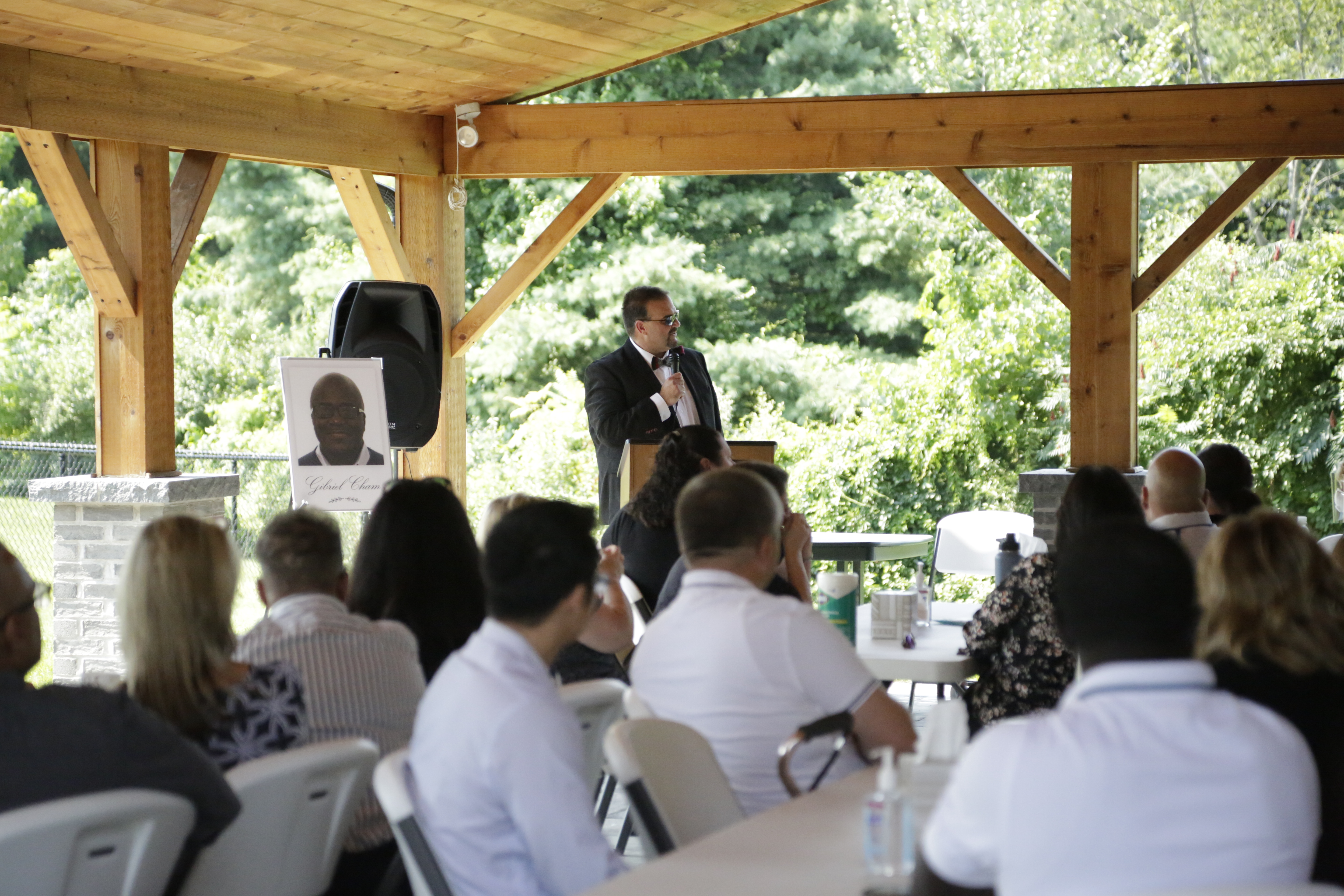 HAI Group President and CEO speaks at a remembrance ceremony for Gibriel Cham in 2021. 